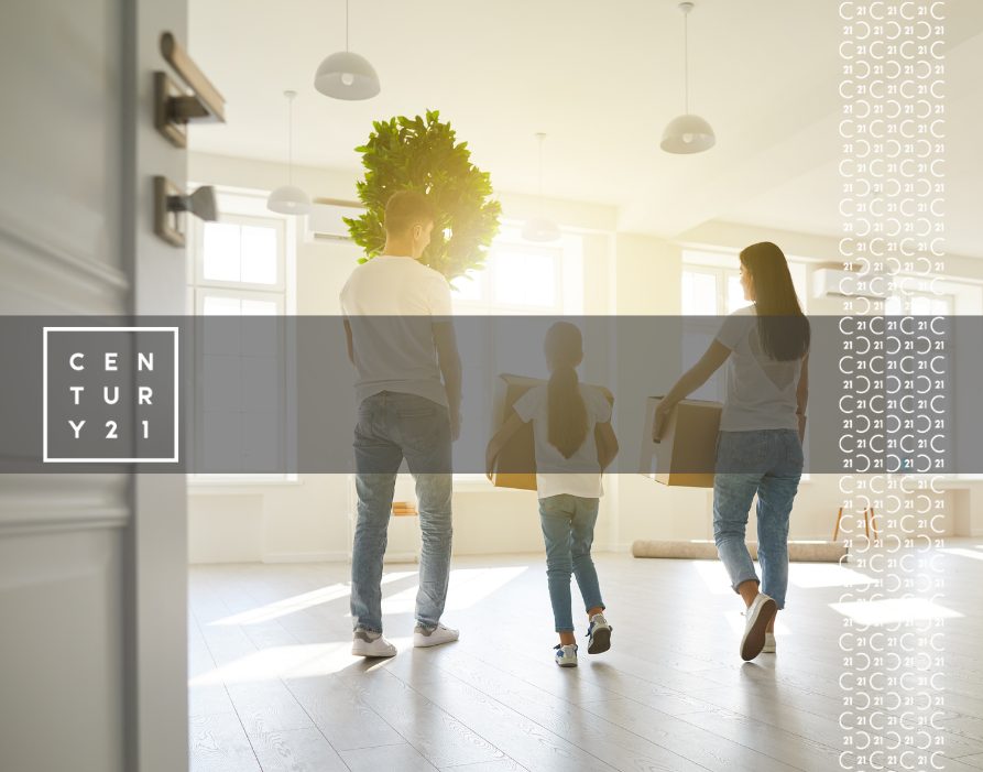 Happy Family with Children Moving with Boxes in a New Apartment House. Back View